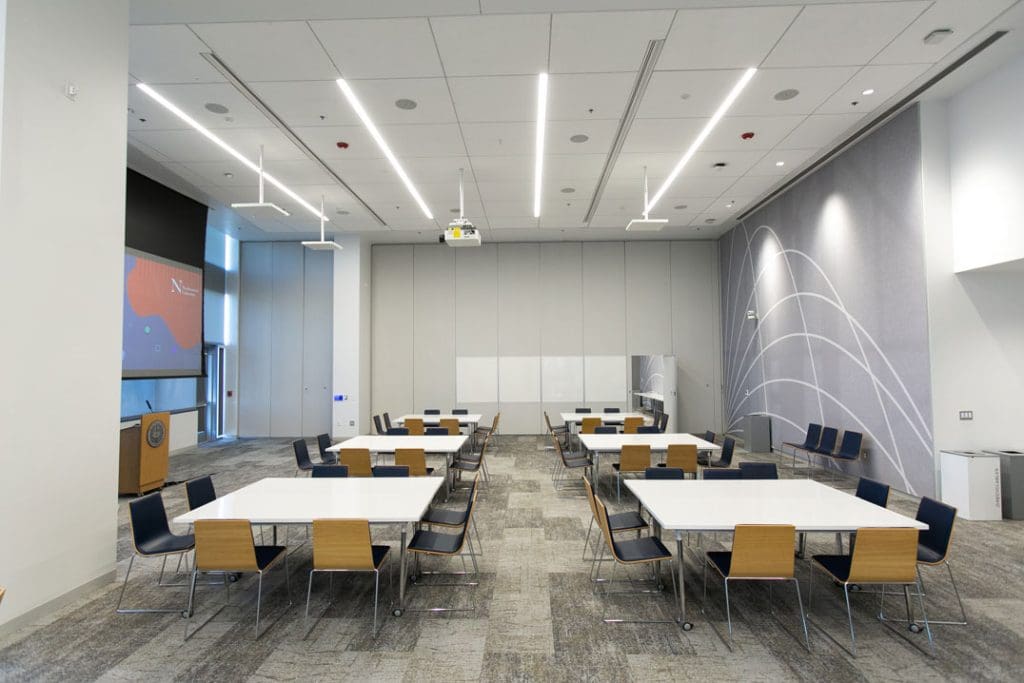 A conference space where tables are set up in square pods