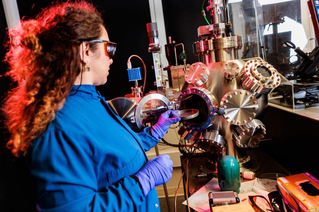 A woman using machinery and equipment in the Materials and Devices lab